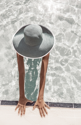 Woman In Sun Hat In The Pool